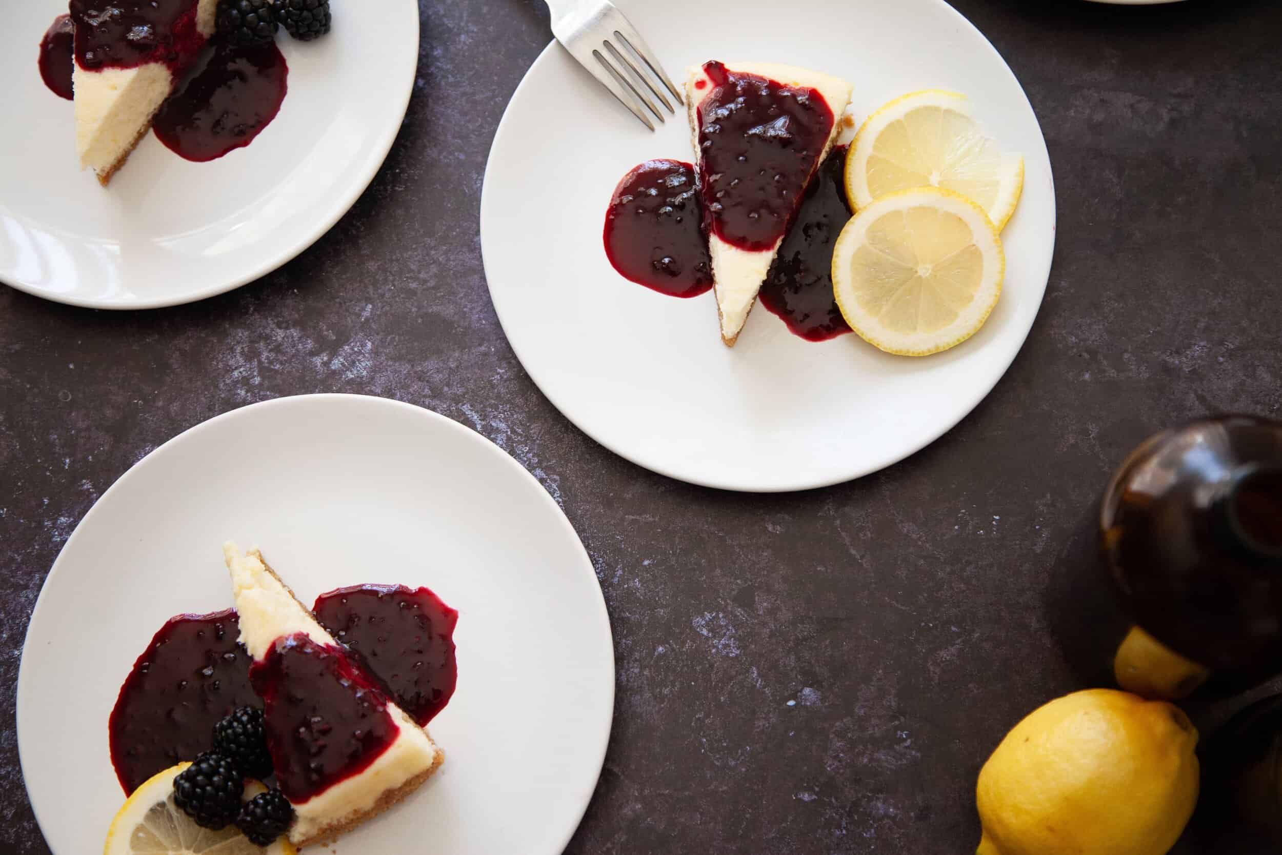 Lemon cheesecake topped with blackberry sauce