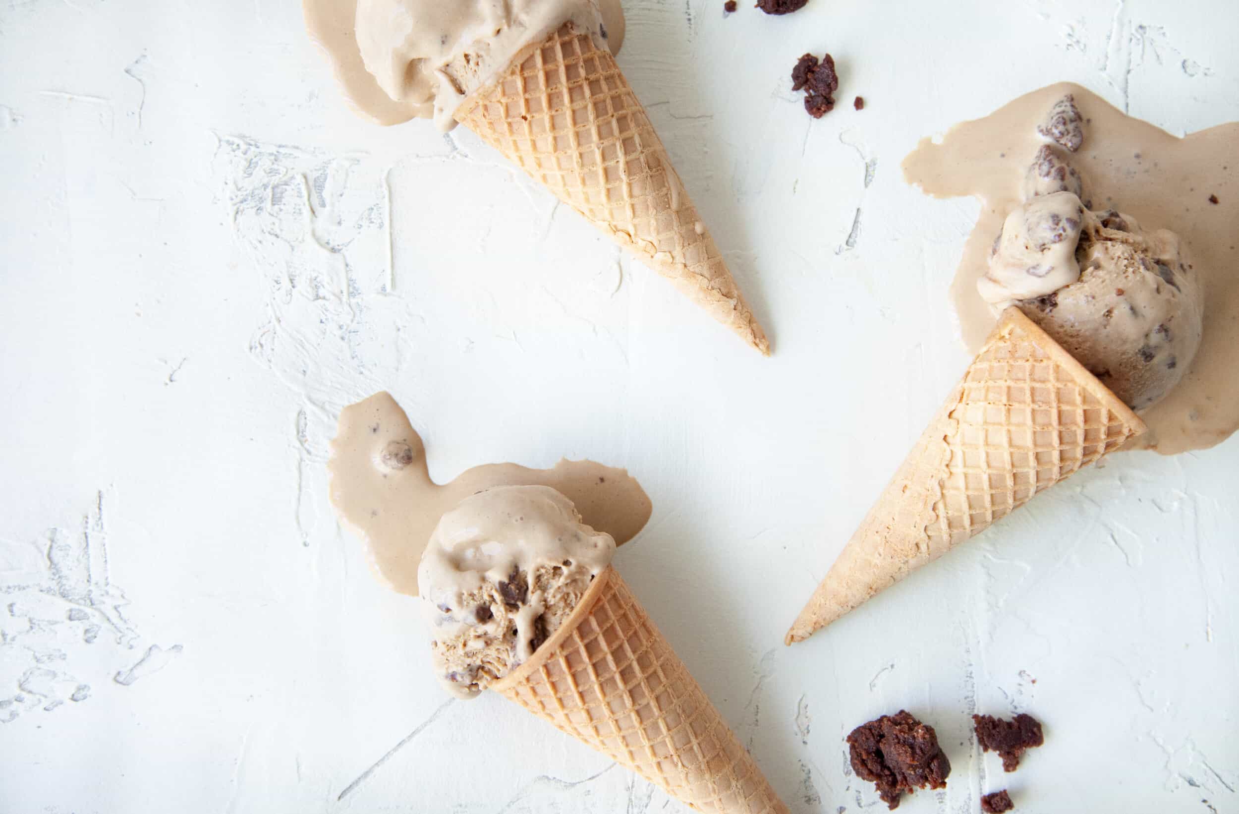 Coffee and brownie ice cream melting in ice cream cones