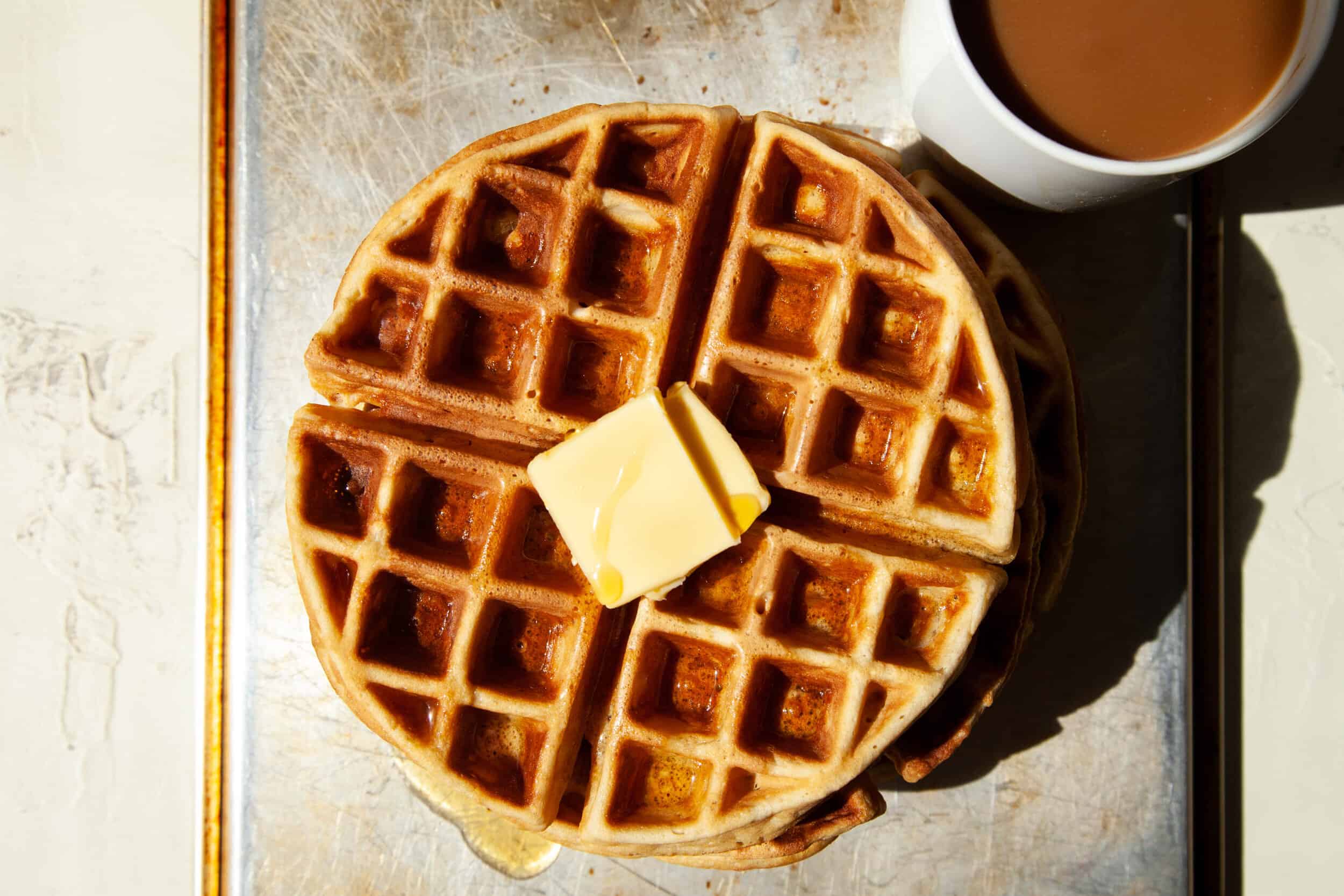 Waffles with butter, syrup, and coffee