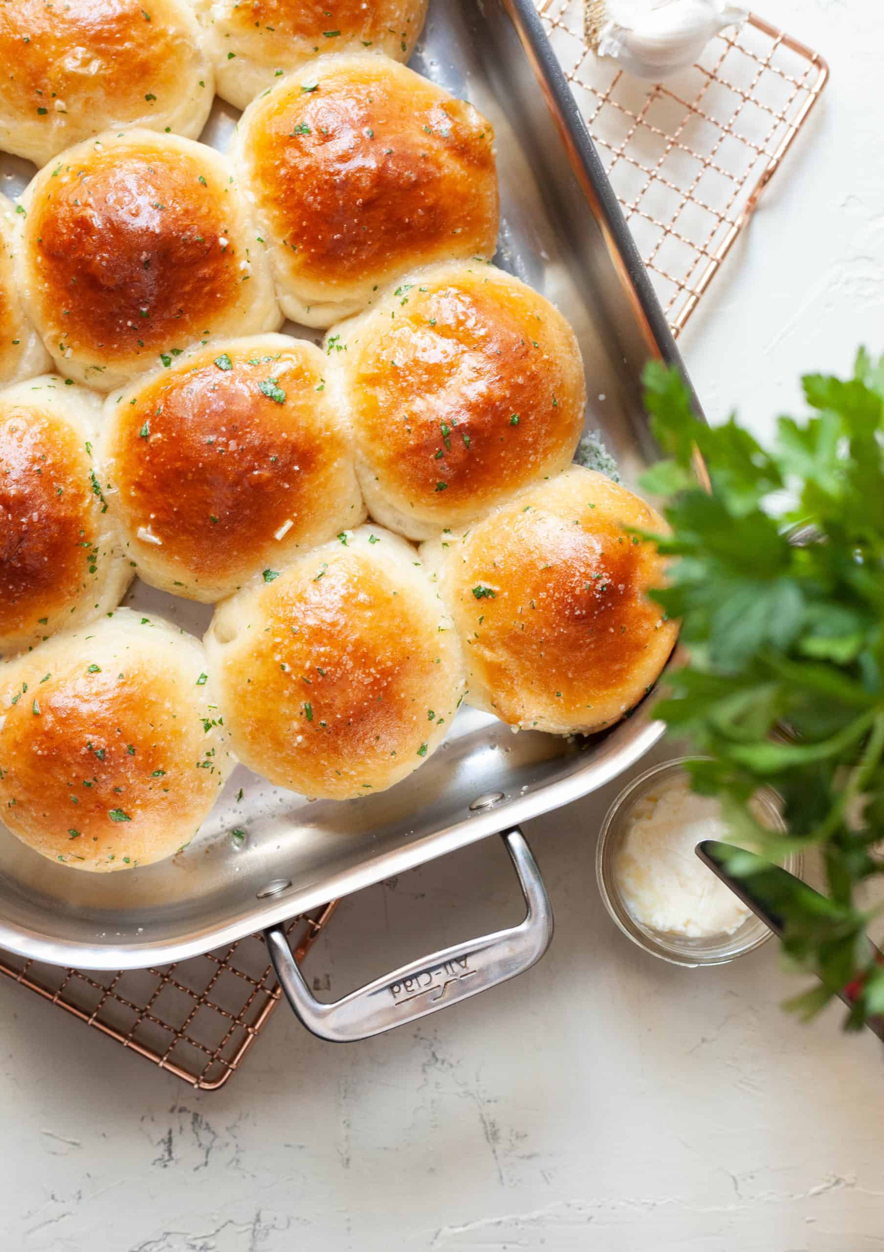 a tray of dinner rolls and parsley