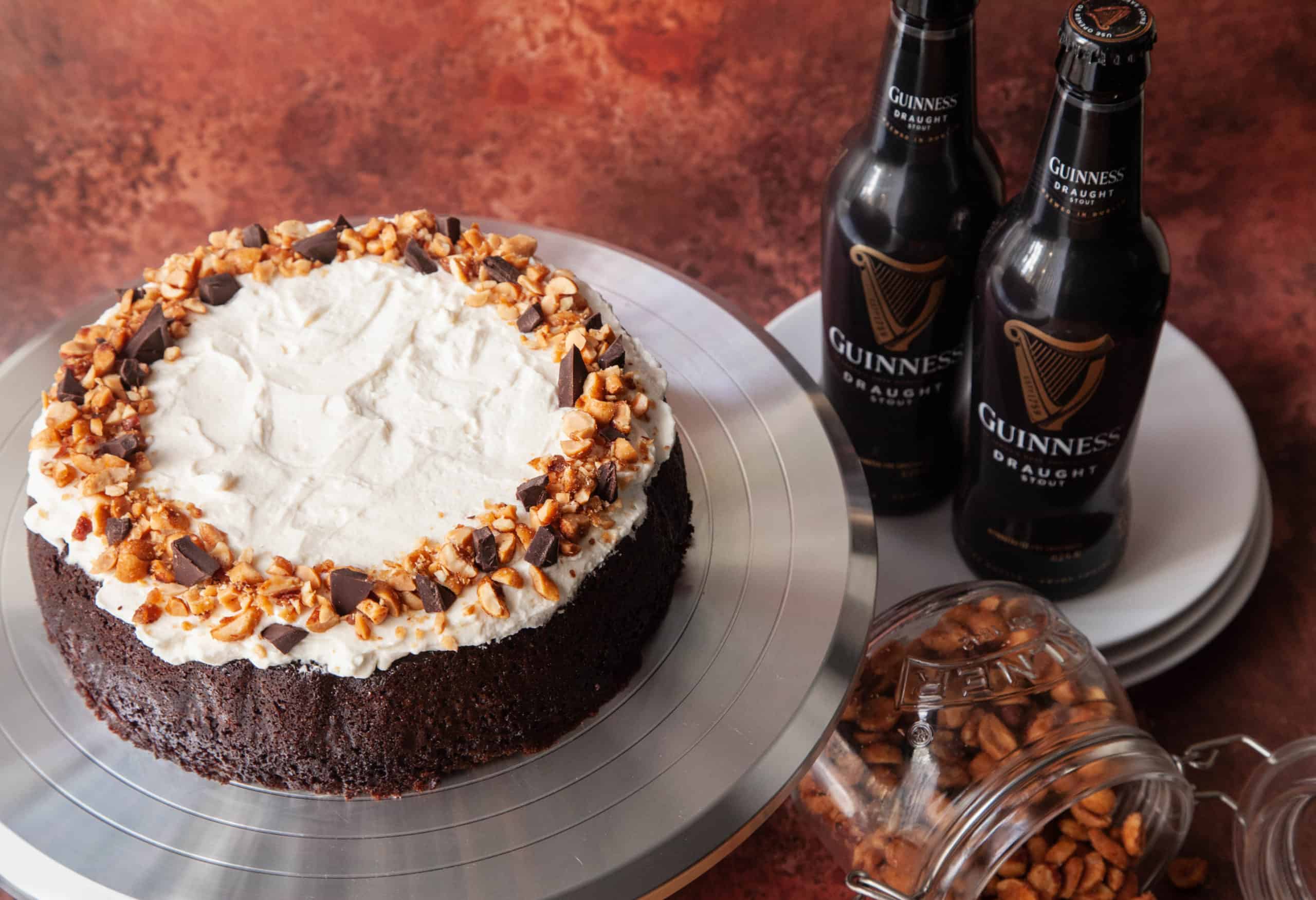 Guinness Chocolate Cake with frosting and two beers