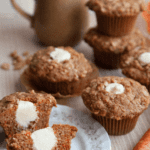 carrot muffin cut in half with cream cheese frosting