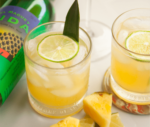 pineapple, coconut, and mezcal margarita with lime garnish